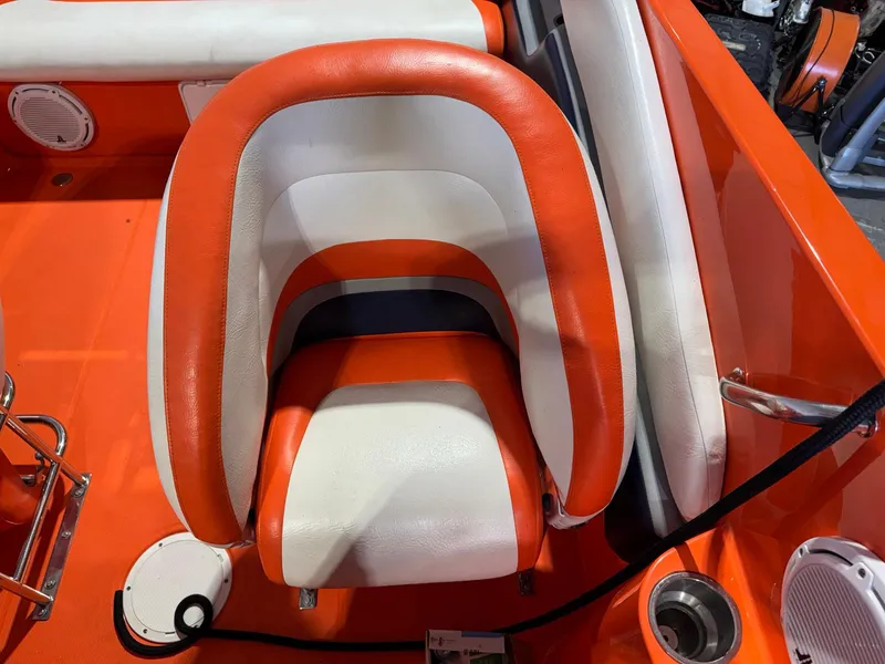 Slide: The Image of 2007 Baja 35 Outlaw boat seat, orange and white upholstery, sleek design. - 27