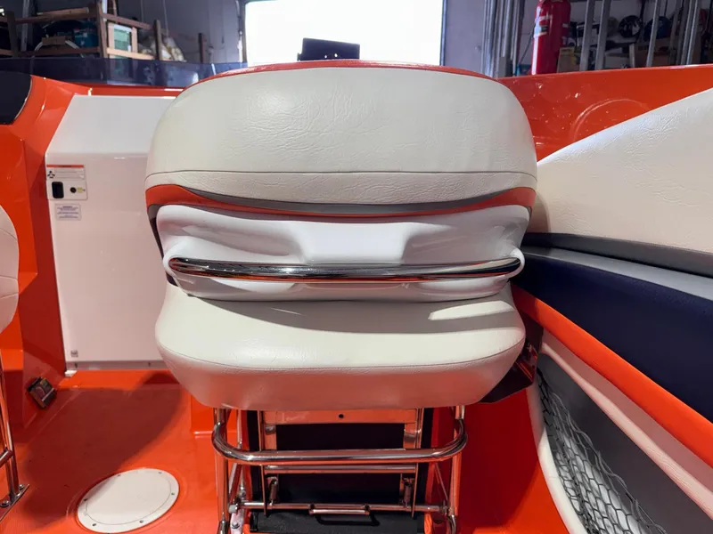 Slide: The Image of 2007 Baja 35 Outlaw boat interior with white and orange seating. - 9