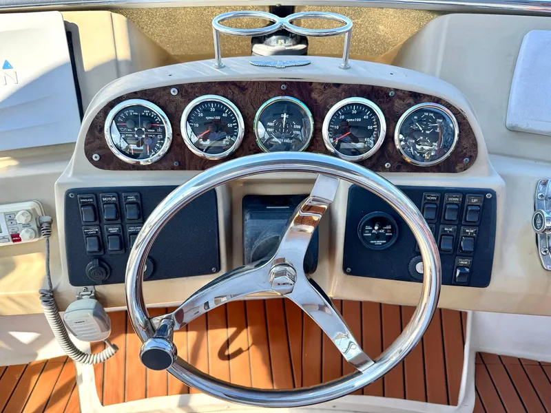 Slide: The Image of Steering wheel and dashboard of 2001 Carver 396 Motor Yacht with gauges and controls. - 9