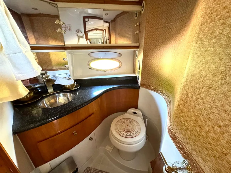 Slide: The Image of Luxurious bathroom in 2001 Carver 396 Motor Yacht with elegant fixtures and wood accents. - 27