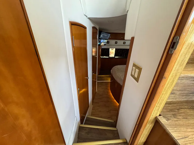 Slide: The Image of Interior hallway of 2001 Carver 396 Motor Yacht with wooden doors and steps. - 29