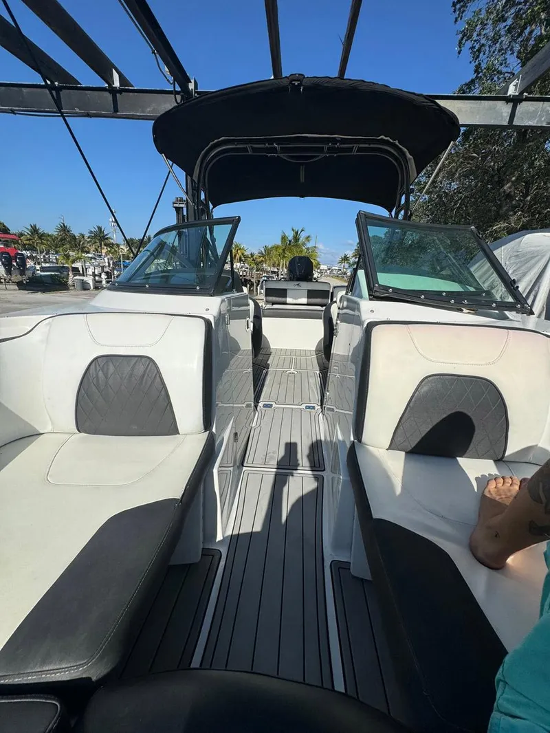 Slide: The Image of 2020 Monterey M45 boat interior with white and black seating, open deck, and canopy. - 13