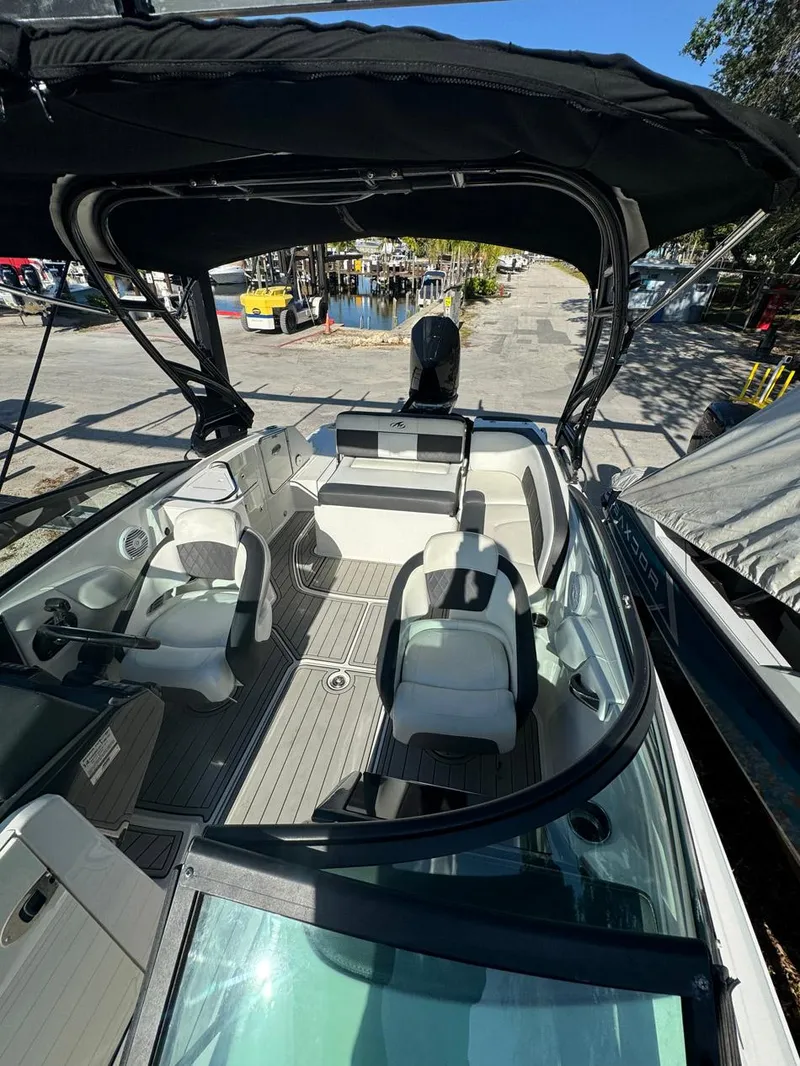 Slide: The Image of 2020 Monterey M45 boat with spacious seating and sleek design, docked at a marina. - 14