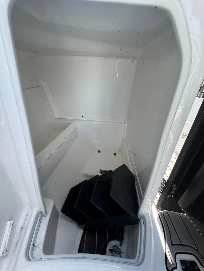 Slide: The Image of Storage compartment in a 2020 Monterey M45 boat, featuring black mats inside. - 16