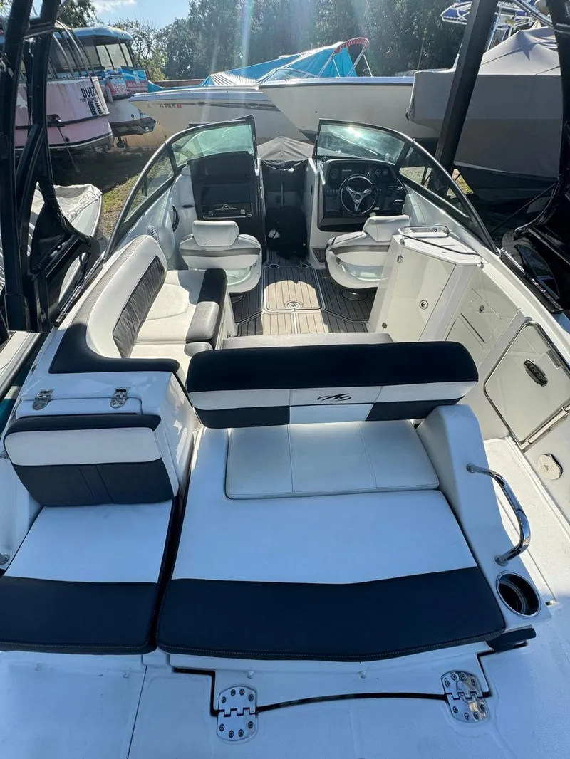 Slide: The Image of 2020 Monterey M45 boat interior with seating and steering wheel, docked outdoors. - 18