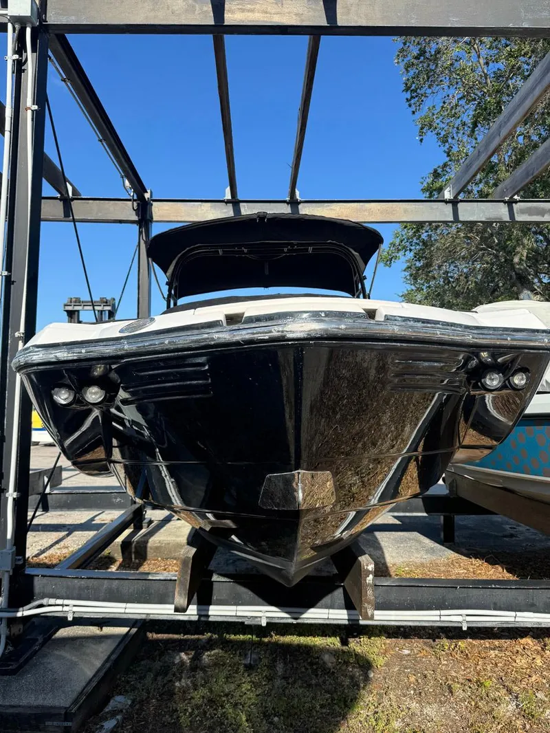 Slide: The Image of 2020 Monterey M45 boat on a lift, front view, under clear blue sky. - 27