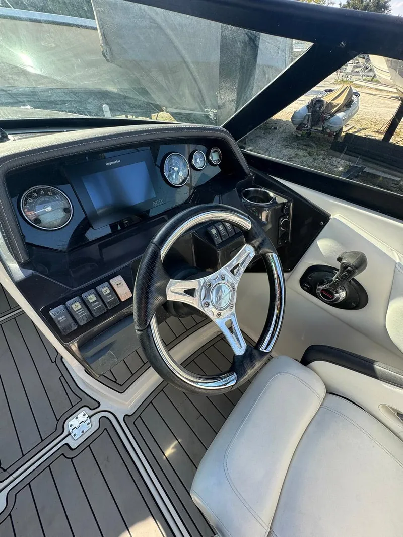 Slide: The Image of Steering wheel and dashboard of a 2020 Monterey M45 boat, featuring modern controls and gauges. - 5