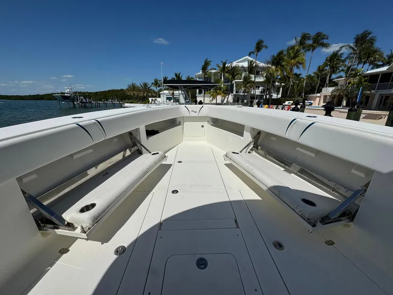Slide: The Image of 2014 SeaVee 390B Center Console boat with spacious seating, docked near waterfront homes. - 11