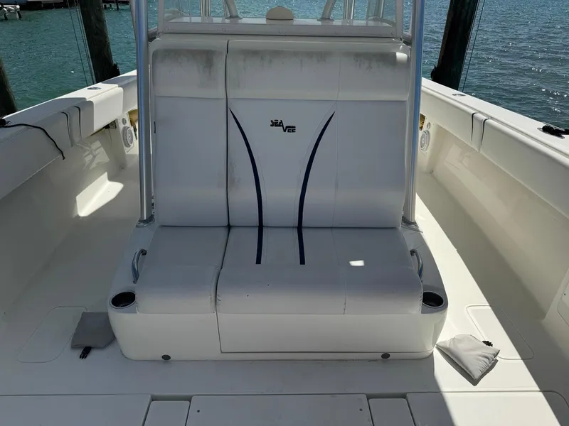 Slide: The Image of 2014 SeaVee 390B Center Console boat interior with white seating and cup holders. - 12