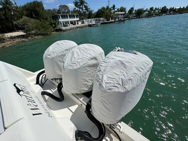 Slide: The Image of 2014 SeaVee 390B Center Console with covered outboard motors on a sunny waterfront. - 17