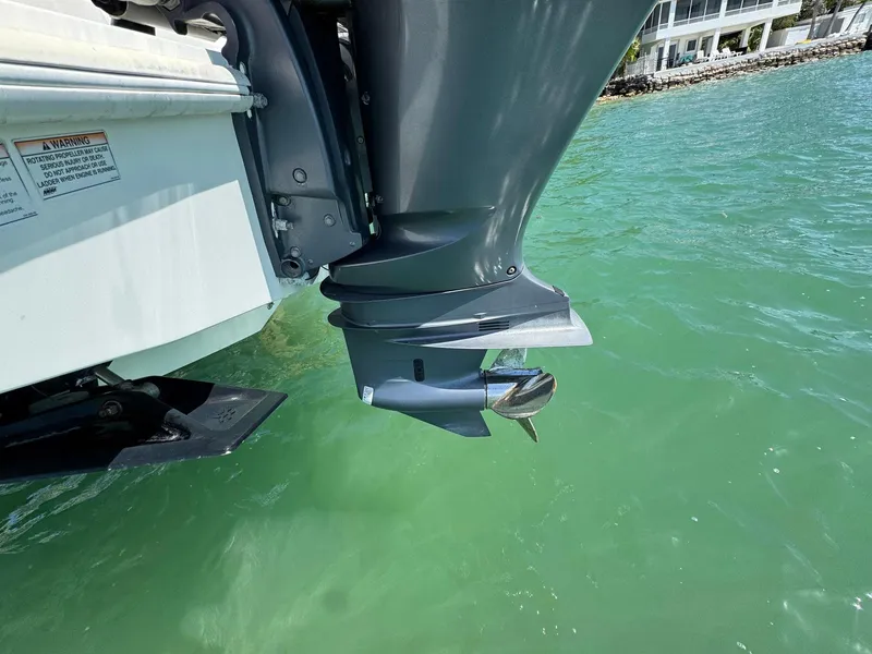 Slide: The Image of Outboard motor of 2014 SeaVee 390B Center Console in clear green water. - 18