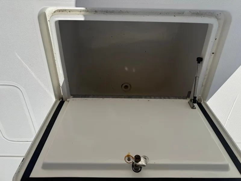 Slide: The Image of 2014 SeaVee 390B Center Console storage compartment with open lid. - 23
