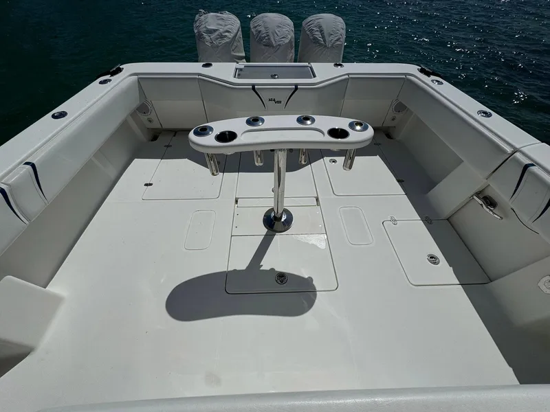 Slide: The Image of 2014 SeaVee 390B Center Console boat deck with rod holders, ocean in background. - 24