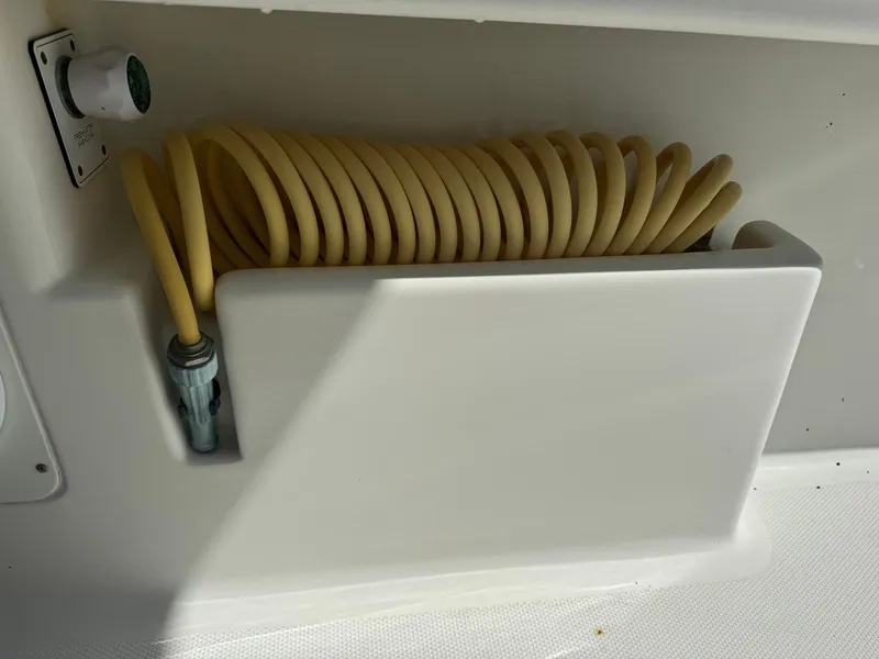 Slide: The Image of Coiled hose storage on 2014 SeaVee 390B Center Console boat. - 26