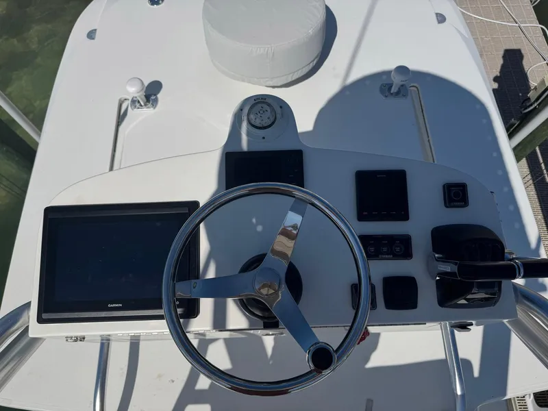 Slide: The Image of 2014 SeaVee 390B Center Console helm with steering wheel and navigation displays. - 36