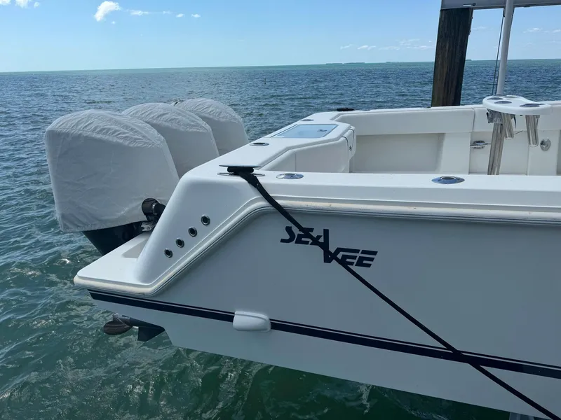 Slide: The Image of 2014 SeaVee 390B Center Console boat docked, featuring triple outboard engines. - 4