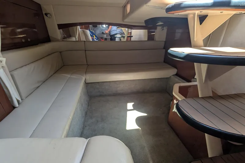 Slide: The Image of Interior of 2008 Sea Ray 340 Sundancer yacht with beige seating and wooden accents. - 13