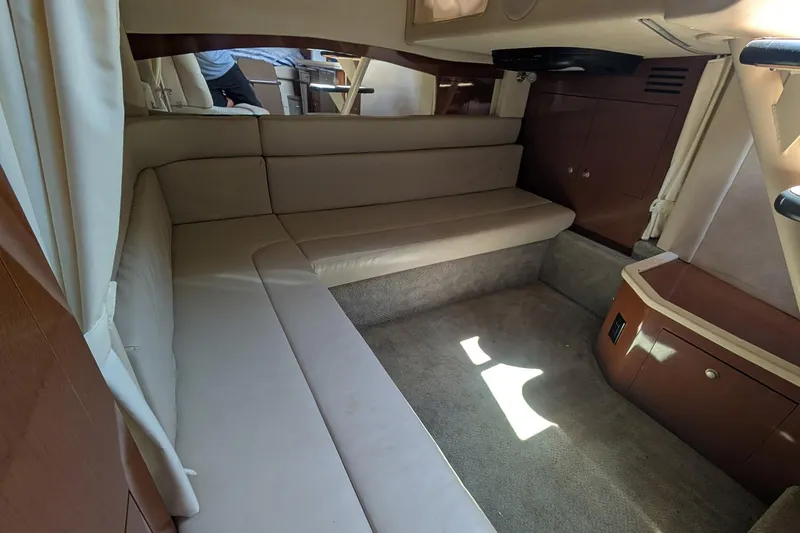 Slide: The Image of Interior of 2008 Sea Ray 340 Sundancer yacht with beige seating and wooden cabinetry. - 14
