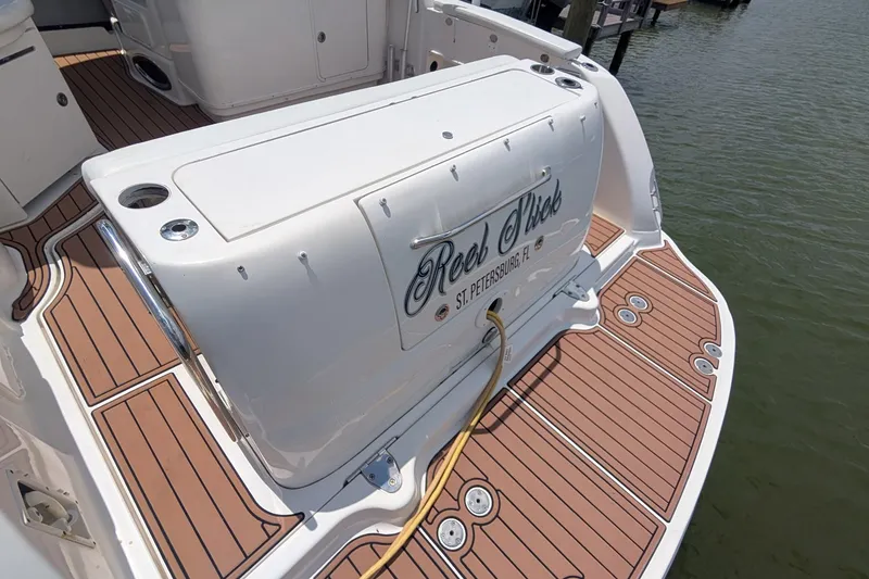 Slide: The Image of 2008 Sea Ray 340 Sundancer boat with teak deck, docked by water. - 2