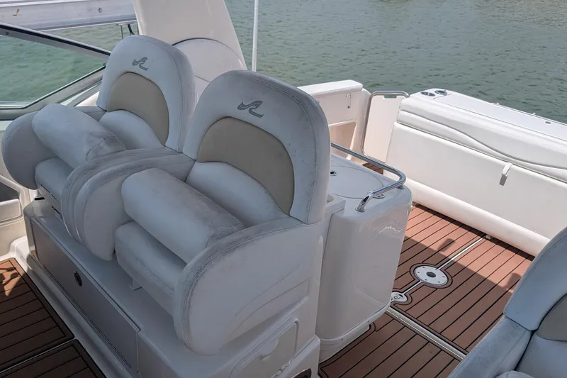 Slide: The Image of 2008 Sea Ray 340 Sundancer boat interior with white seating and teak flooring. - 5