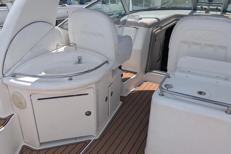Slide: The Image of 2008 Sea Ray 340 Sundancer interior with seating and sink on teak deck. - 7