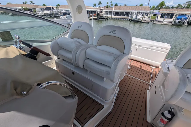 Slide: The Image of 2008 Sea Ray 340 Sundancer cockpit with plush seating and waterfront view. - 8