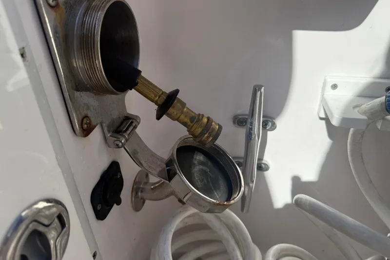 Slide: The Image of Fuel inlet and hose on a 2017 Fountain 38 Sportfish Cruiser boat. - 10