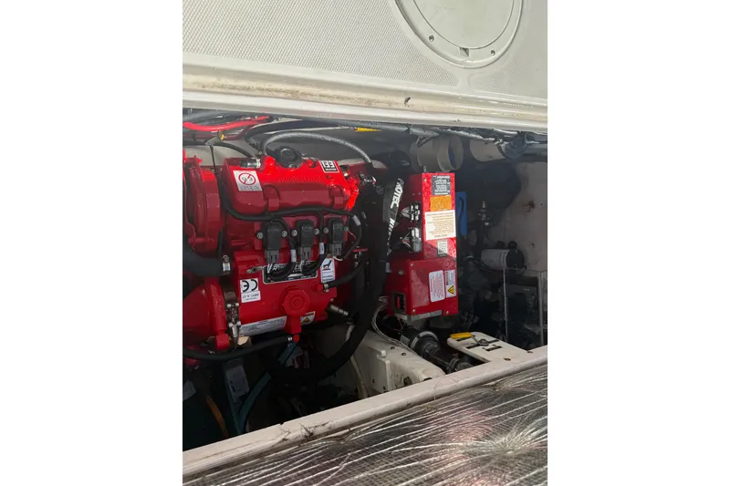 Slide: The Image of Engine compartment of 2017 Fountain 38 Sportfish Cruiser, showcasing red engine components. - 16