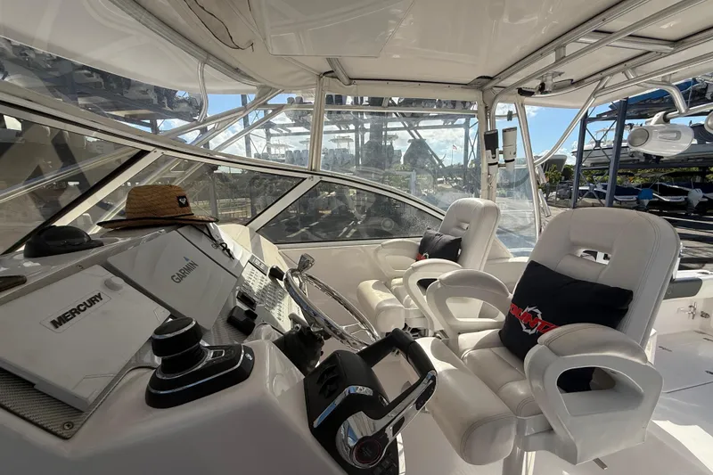 Slide: The Image of 2017 Fountain 38 Sportfish Cruiser cockpit with white seating and navigation equipment. - 28