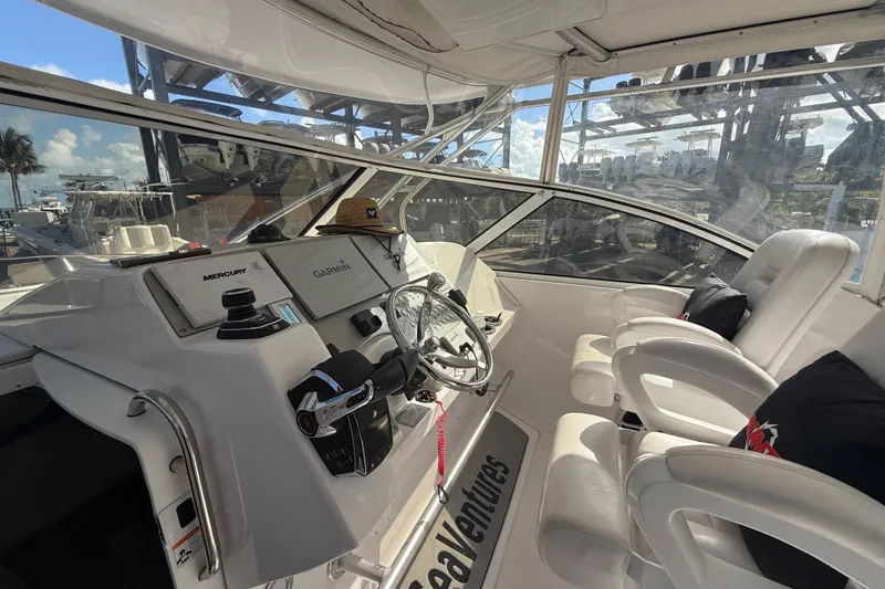 Slide: The Image of 2017 Fountain 38 Sportfish Cruiser helm with Garmin and Mercury controls, white seating. - 29