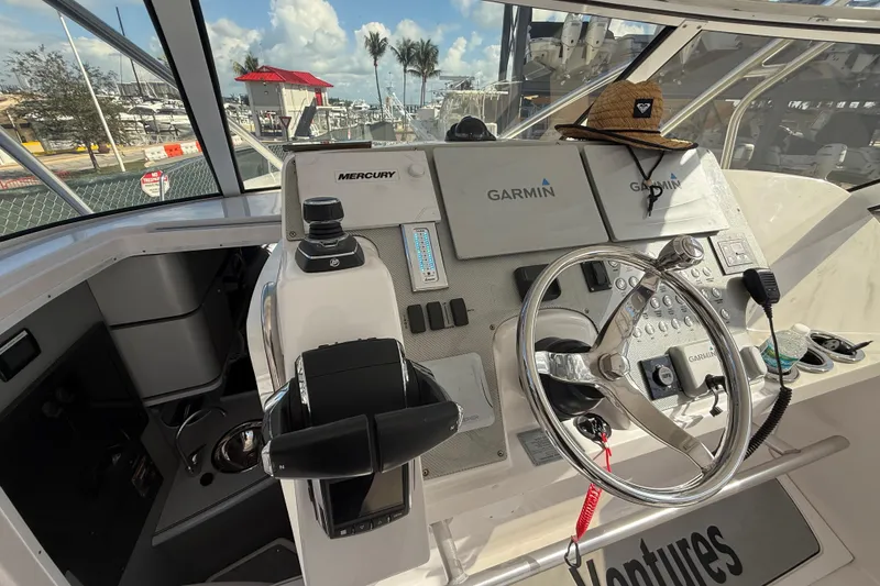 Slide: The Image of 2017 Fountain 38 Sportfish Cruiser helm with Garmin navigation and Mercury controls. - 31