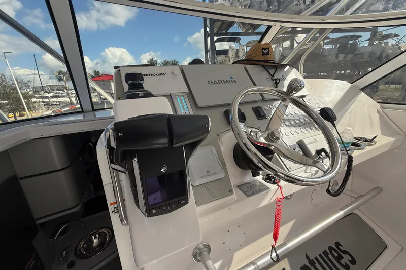 Slide: The Image of 2017 Fountain 38 Sportfish Cruiser helm with Garmin and Mercury controls. - 34