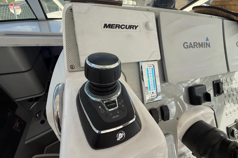 Slide: The Image of Control panel of 2017 Fountain 38 Sportfish Cruiser with Mercury and Garmin systems. - 35