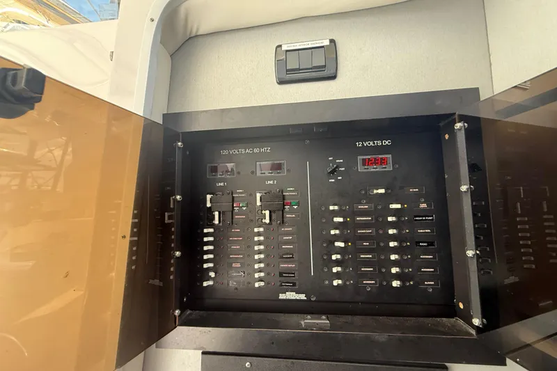 Slide: The Image of Electrical panel on 2017 Fountain 38 Sportfish Cruiser, showcasing AC and DC voltage controls. - 41