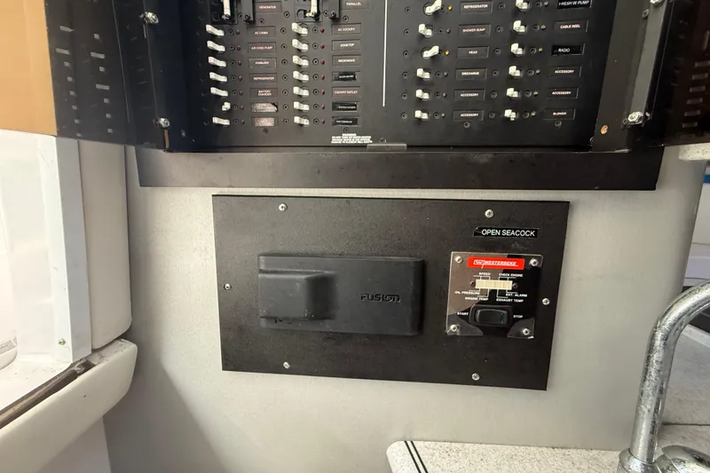 Slide: The Image of Control panel of a 2017 Fountain 38 Sportfish Cruiser boat, featuring switches and gauges. - 42