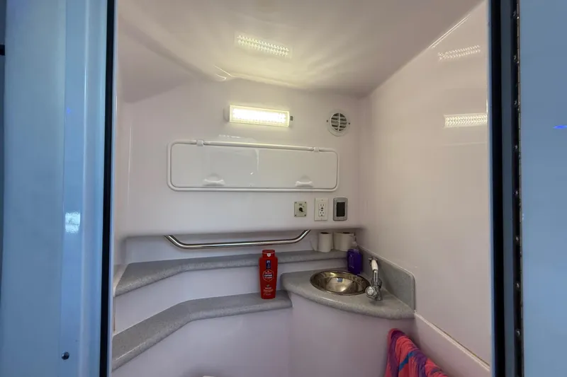 Slide: The Image of 2017 Fountain 38 Sportfish Cruiser bathroom with sink, towel, and toiletries. - 52