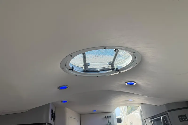 Slide: The Image of Ceiling view of 2017 Fountain 38 Sportfish Cruiser with round hatch and blue LED lights. - 54