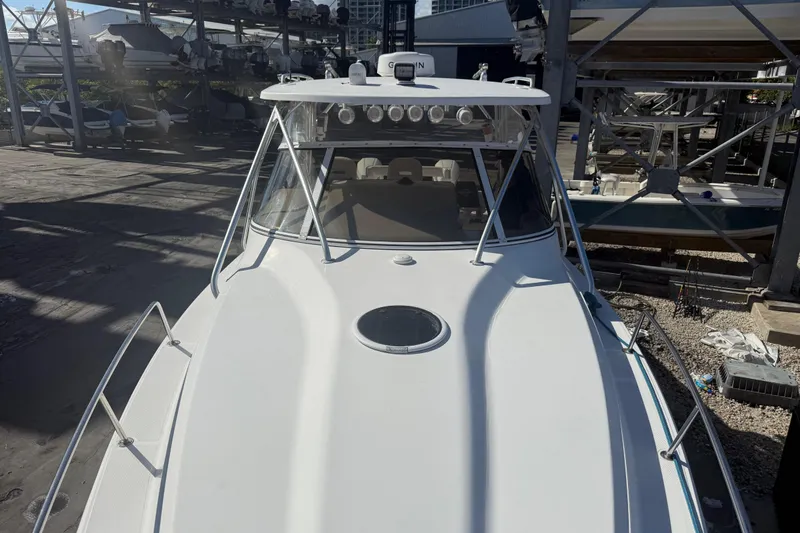 Slide: The Image of 2017 Fountain 38 Sportfish Cruiser docked, showcasing sleek design and spacious deck. - 57