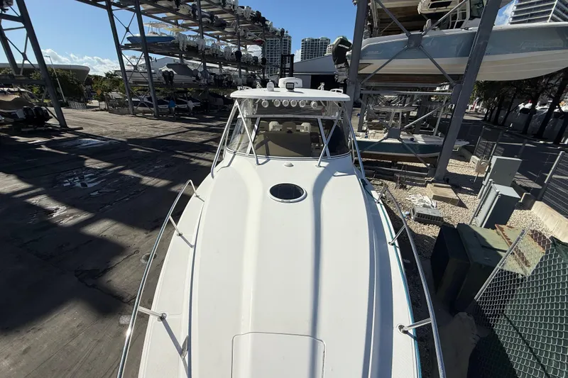 Slide: The Image of 2017 Fountain 38 Sportfish Cruiser docked in a marina with stacked boats. - 58