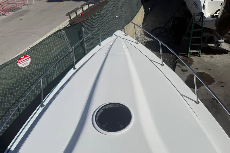 Slide: The Image of 2017 Fountain 38 Sportfish Cruiser bow view in a marina setting. - 62