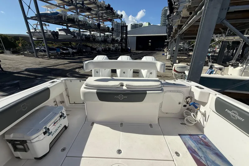 Slide: The Image of 2017 Fountain 38 Sportfish Cruiser boat interior at marina with stacked boats in background. - 7