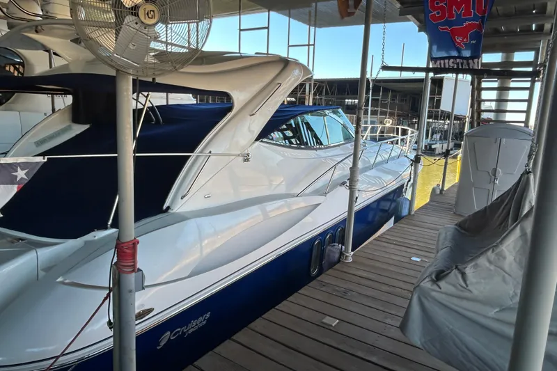 Slide: The Image of 2005 Cruisers 500 yacht docked in marina, featuring sleek design and blue accents. - 11