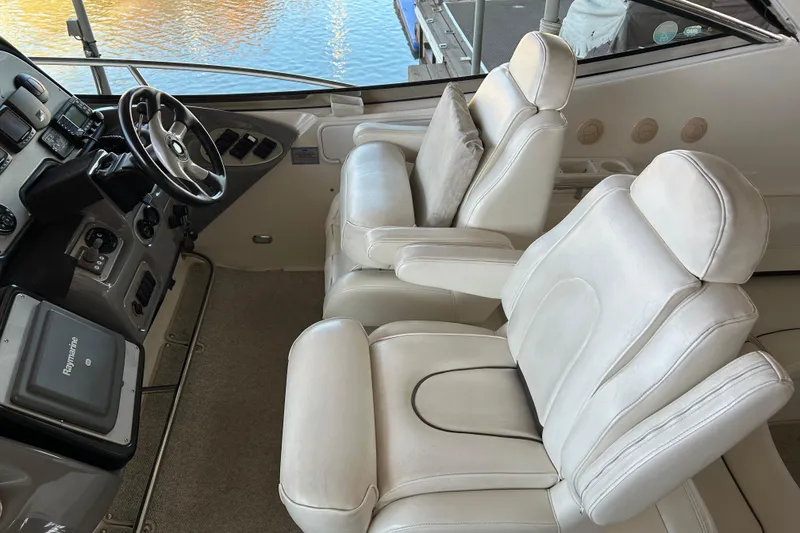 Slide: The Image of Luxurious 2005 Cruisers 500 yacht interior with plush white captain's chairs and steering console. - 19
