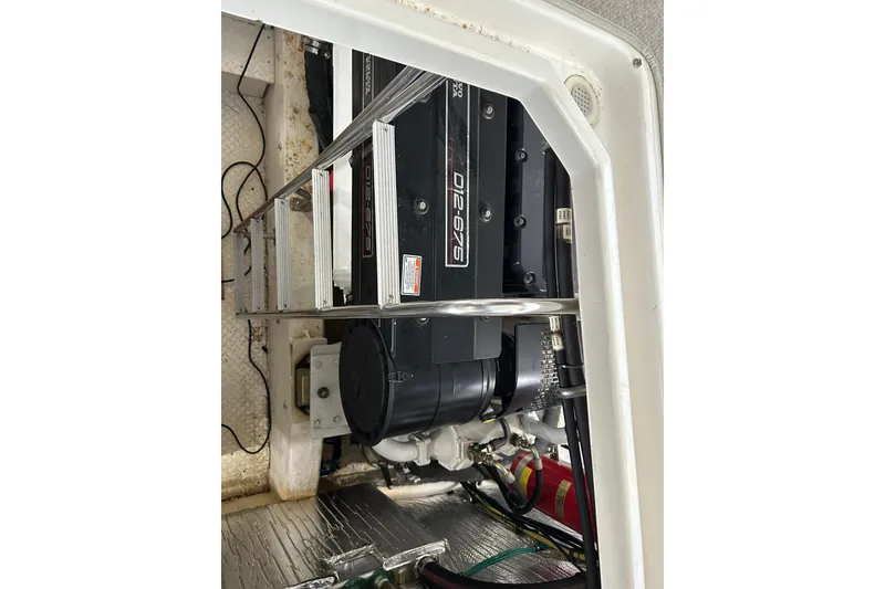 Slide: The Image of Engine compartment of a 2005 Cruisers 500 boat, featuring a D12-675 engine. - 35