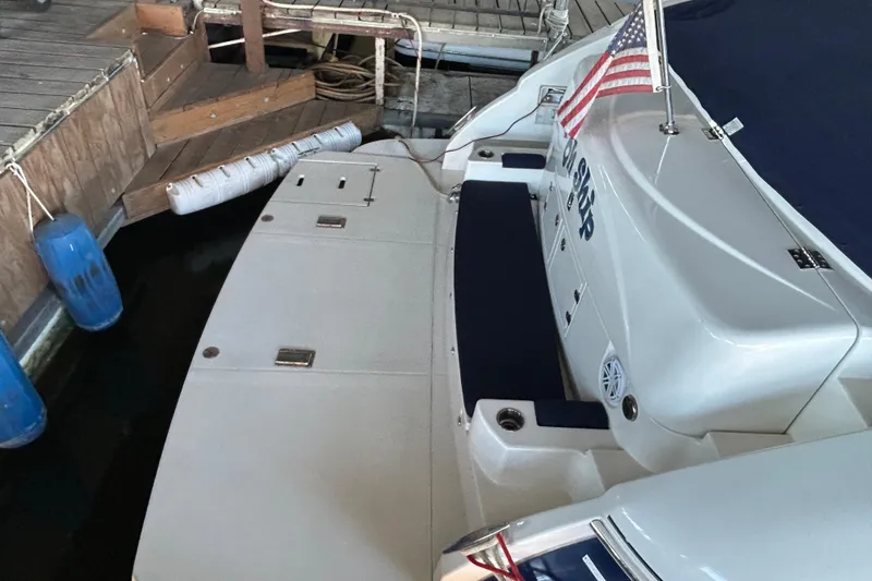 Slide: The Image of 2005 Cruisers 500 yacht docked, featuring swim platform and American flag. - 10