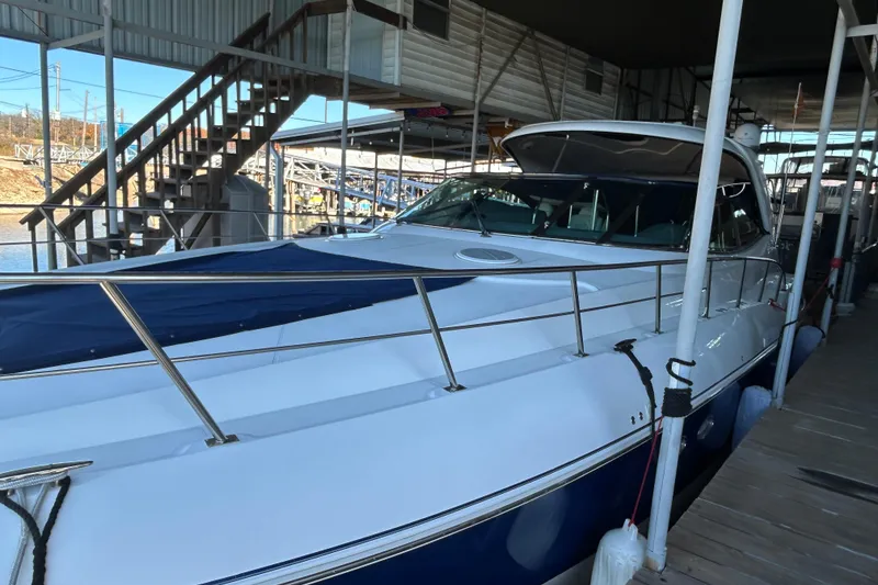 Slide: The Image of 2005 Cruisers 500 yacht docked in a marina under a covered structure. - 13
