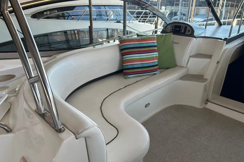 Slide: The Image of 2005 Cruisers 500 yacht interior with white seating and colorful cushions. - 18