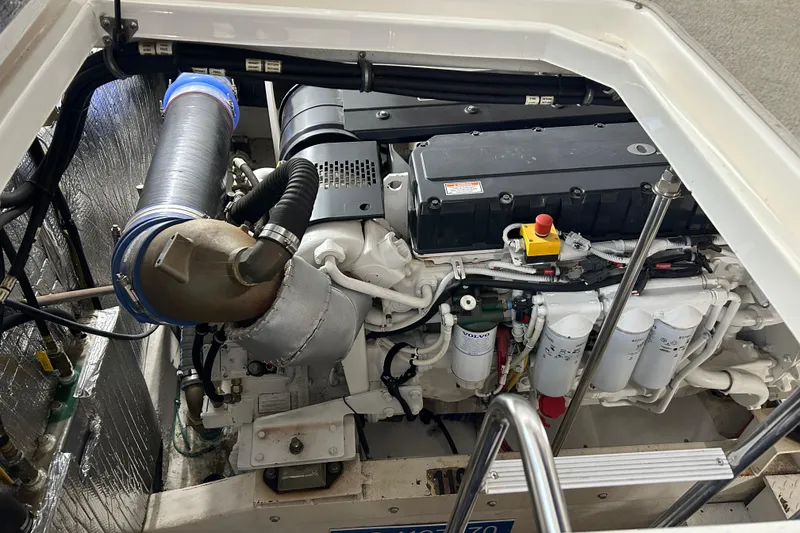 Slide: The Image of Engine compartment of a 2005 Cruisers 500 boat, showcasing detailed mechanical components. - 34