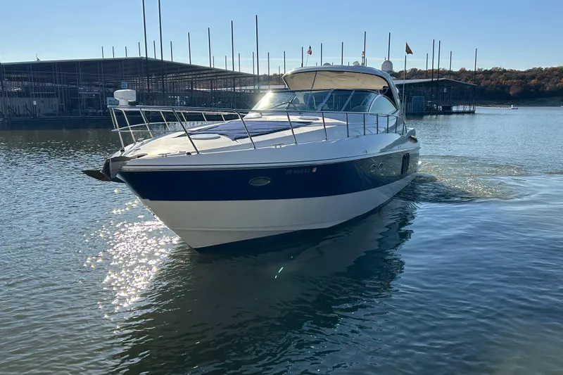 Slide: The Image of 2005 Cruisers 500 yacht on calm water near marina. - 37