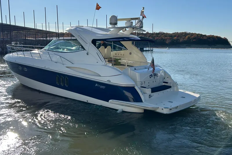 Slide: The Image of 2005 Cruisers 500 yacht on water, blue and white design, sunny day. - 4